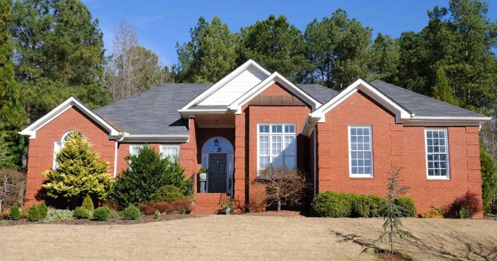 A large brick home on a sunny day.