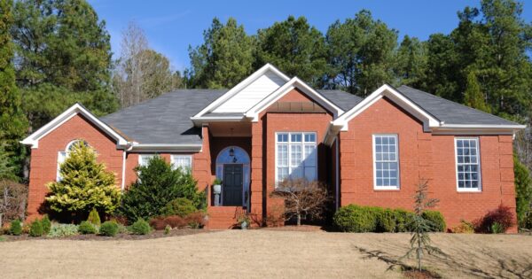A large brick home on a sunny day.