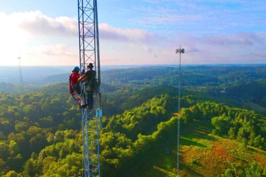 Two Smart Way Communications staff members on a wireless internet tower